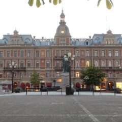 Pampig tegelbyggnad med tinnar och klocktorn.