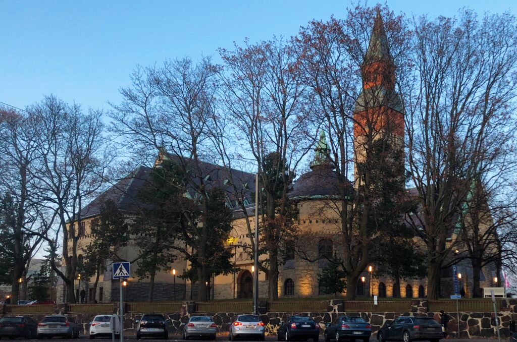 Museibyggnad med träd och bilar framför